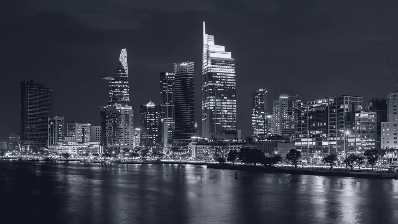 A city skyline at night across water