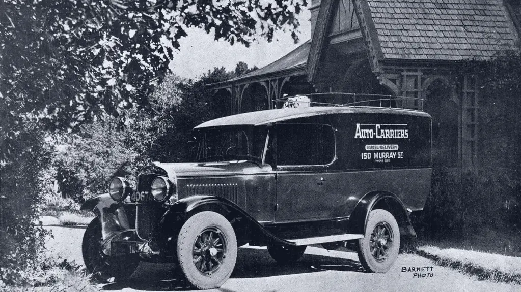 An early delivery van parked outside a house
