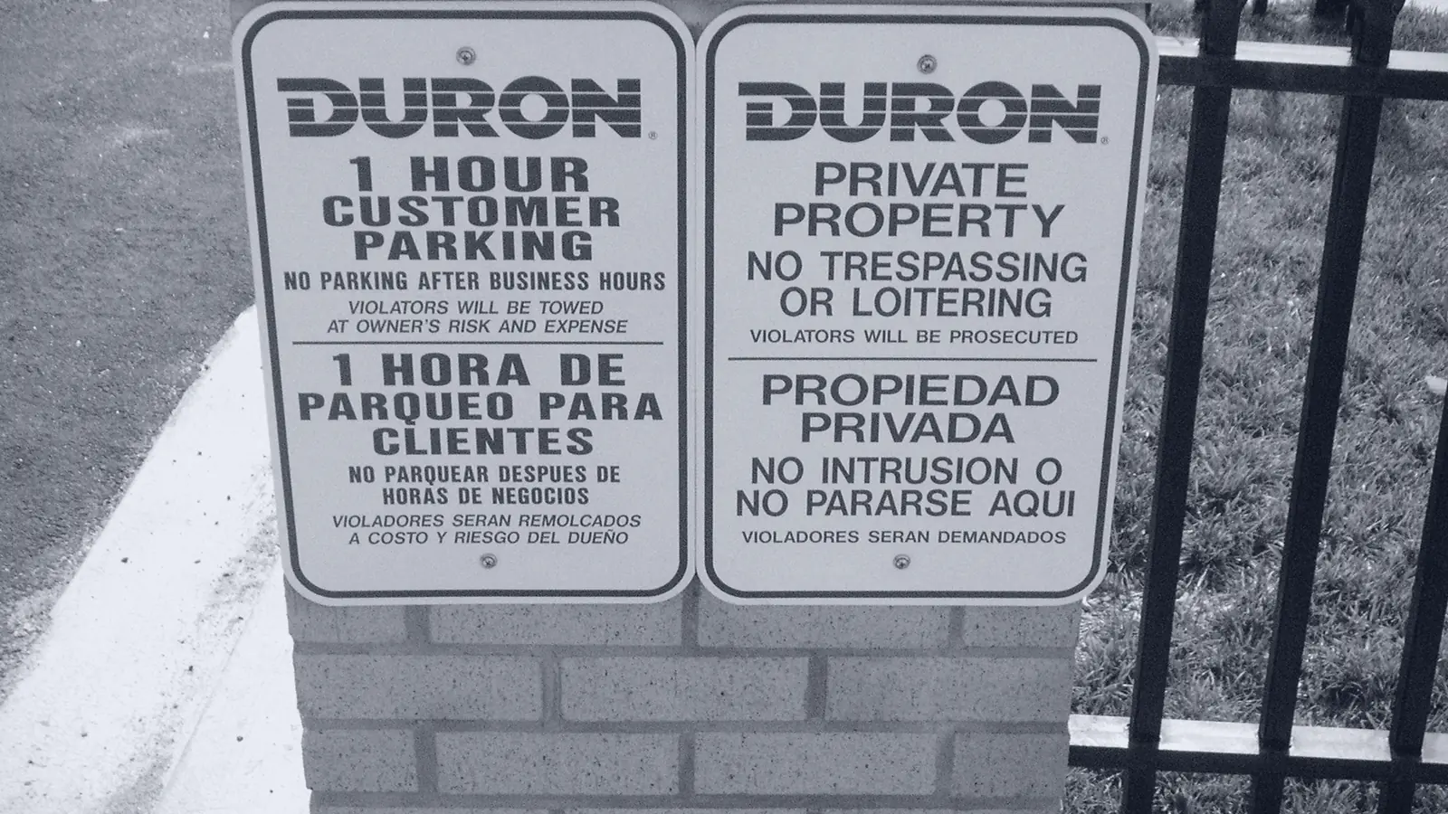 Two parking signs saying the same thing in two languages